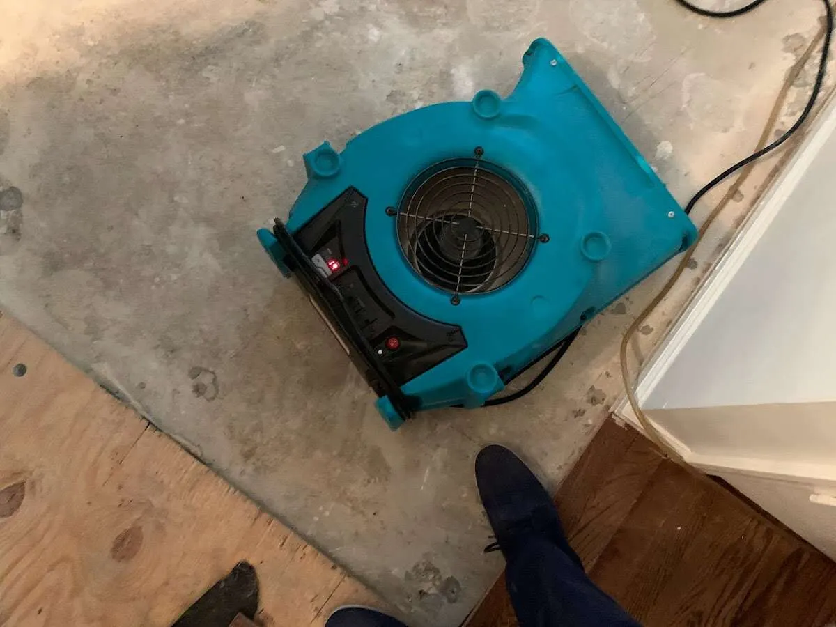 Air mover drying subfloor during Commercial Water Damage Restoration in Guymon